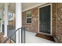 Inviting brick front porch with classic columns and a dark front door, creating a warm welcome at 1648 Danbury Parc Ne Pl, Brookhaven, GA 30319