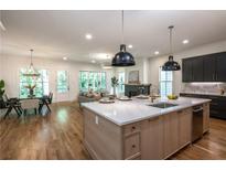 Bright open-concept kitchen features a large island, modern cabinets, and stainless steel appliances at 2164 James Aly, Atlanta, GA 30345