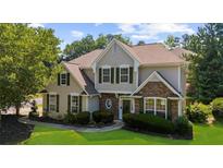 Charming two-story home featuring stone accents, green shutters, and lush landscaping at 3559 Reservoir Pass, Acworth, GA 30101