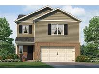Two-story home with neutral siding, brick accents, attached garage, and well-manicured landscaping at 504 Oak View Ln, Dallas, GA 30157