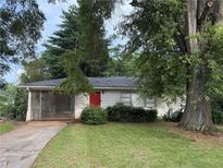 Charming single-story home with a well-maintained lawn and a vibrant red front door at 5341 Old Floyd Sw Rd, Mableton, GA 30126