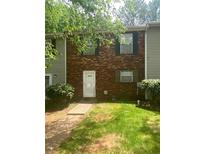 Charming brick townhouse with green shutters and a well-maintained front lawn, creating a welcoming curb appeal at 8955 Stonebridge Blvd, Douglasville, GA 30134