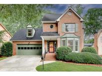 Charming brick home featuring a two-car garage, manicured landscaping, and inviting front entrance at 1685 Frazier Park Dr, Decatur, GA 30033