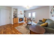 Inviting living room featuring a fireplace, hardwood floors, and access to a balcony at 1150 Collier Nw Rd # G8, Atlanta, GA 30318