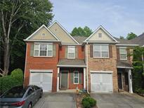 Charming townhome with a brick facade, attached garage, and well-maintained landscaping at 2131 Meadow Peak Rd, Duluth, GA 30097