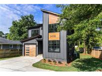 Modern two-story home featuring a gray facade, natural wood accents, and a stylish garage door at 2608 Argo Drive Southeast Se Dr, Smyrna, GA 30080