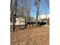 Charming single-Gathering home with a traditional design and a front yard covered in fallen leaves at 3415 Spring Valley Blvd, Atlanta, GA 30349