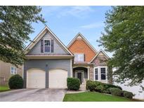 Charming two-story home featuring a two-car garage, stone accents, and well-manicured landscaping at 3610 Chestnut Meadows Dr, Douglasville, GA 30135