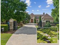 Grand estate with gated entrance, mature trees, and long driveway leading to the main house at 4935 Stablegate Ct, Cumming, GA 30028