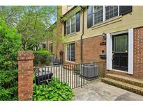 Charming brick townhouse featuring a small, fenced front patio at 1634 Ponce De Leon Ne Ave # 514, Atlanta, GA 30307