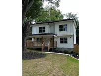 Charming two-story home with a cozy front porch and well-manicured lawn at 1962 Compton Se Dr, Atlanta, GA 30315