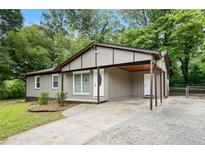 Charming single story home with a cozy carport and well-maintained landscaping at 6658 Collins Ct, Riverdale, GA 30274