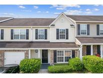 Charming two-story townhome with a manicured front yard and attached garage at 2183 Miranda Dr, Morrow, GA 30260