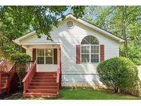 Charming single-story home featuring a bright exterior, front porch, and neatly landscaped yard at 4230 Pilgrim Point Rd, Cumming, GA 30041