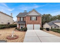 Charming two-story brick home with a well-maintained lawn and two-car garage at 5734 Union Pointe Dr, Union City, GA 30291