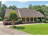 Charming brick home featuring a welcoming front porch and well-manicured lawn at 169 Robson Trl, Mcdonough, GA 30252