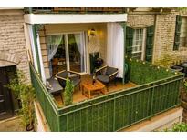 Relaxing patio with wood flooring, seating, and privacy greenery at 2805 Ne Expressway Ne # B 16, Atlanta, GA 30345