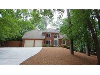 Charming two-story brick home featuring a two-car garage and a well-manicured front yard at 5190 Southlake Dr, Alpharetta, GA 30005