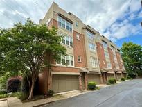 Attractive townhome exterior with brick facade, private garages, and manicured landscaping in a desirable neighborhood at 1376 Parkview Ne Ln, Atlanta, GA 30324