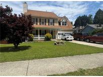 Traditional two-story home featuring a well-manicured lawn and welcoming front porch at 2295 Eagle Pointe Ct, Lawrenceville, GA 30044