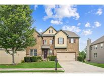 Charming two-story brick home with a well-manicured lawn and attached two-car garage at 2755 Evan Manor Ln, Cumming, GA 30041