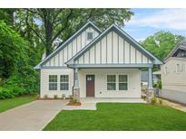 Charming exterior of a home featuring a manicured lawn and neutral paint scheme at 623 Hamilton E Holmes Nw Dr, Atlanta, GA 30318