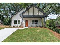 Charming home featuring a modern facade, complemented by a well-maintained lawn and an inviting, covered front porch at 623 Hamilton E Holmes Nw Dr, Atlanta, GA 30318