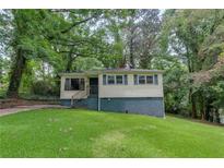 Charming home with a well-maintained lawn and mature trees at 629 Hickory Se Trl, Mableton, GA 30126