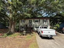 Charming two-story home with a cozy front yard and inviting curb appeal at 135 Woodcrest Dr, Covington, GA 30016