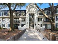 Elegant condo building featuring a striking entrance, balconies, and well-maintained landscaping at 2119 Pine Heights Ne Dr, Atlanta, GA 30324
