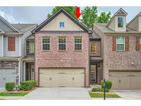Charming two-story townhome with a two-car garage and manicured landscaping at 3280 Hallmark Ln, Buford, GA 30519