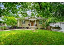 Charming home with a manicured lawn, featuring a cozy entrance and lush landscaping at 1734 8Th St, Brookhaven, GA 30341