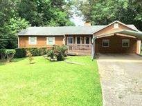 Charming home with well-maintained lawn and a covered carport, perfect for easy parking at 2691 Tucson Way, Powder Springs, GA 30127