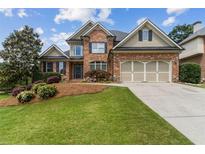 Charming brick two-story home with manicured lawn and beautiful landscaping at 1408 Chloe Dr, Lawrenceville, GA 30043