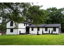 Charming two-story home featuring white brick and siding with a well-manicured lawn at 69 N Hearn Rd, Ellenwood, GA 30294