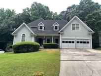 Charming two-story home featuring a well-manicured lawn and a classic suburban design at 71 Southern Golf Ct, Fayetteville, GA 30215