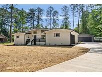 Charming renovated home with fresh white paint, black trim, and a detached two car garage at 974 Clydesdale Dr, Marietta, GA 30062