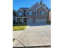 Beautiful brick two-story home with well-manicured lawn and spacious driveway at 3675 Brookhollow Dr, Douglasville, GA 30135