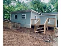 View of the rear exterior elevation with a wooden ramp and steps leading to a porch at 5153 Westbrook Pl, Union City, GA 30291