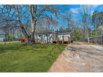 Charming home featuring a wooden ramp and a lush green lawn at 5153 Westbrook Pl, Union City, GA 30291