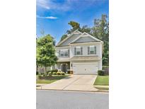 Charming two-story home with a well-manicured lawn and a two-car garage in a peaceful residential neighborhood at 137 Prominence Ct, Canton, GA 30114