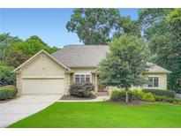 Charming ranch-style home featuring a two-car garage, manicured lawn, and mature trees, perfect for suburban living at 2676 Varner Ne Dr, Atlanta, GA 30345