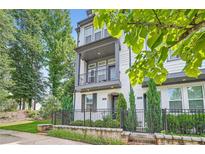 Beautiful two-story home featuring a quaint balcony, freshly painted white brick, and manicured landscaping at 816 S Columbia Dr, Decatur, GA 30030