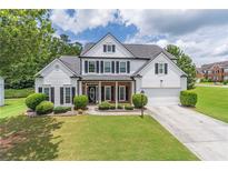 Charming two-story home featuring a well-manicured lawn and traditional design elements at 3906 Elm Trace Ct, Loganville, GA 30052