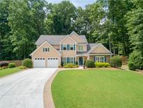 Charming two-story home with a well-manicured lawn and a two-car garage at 4204 Woodfare Nw Ln, Kennesaw, GA 30152