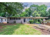 Charming single story home with a carport and well-manicured front yard at 1538 Belva Ave, Decatur, GA 30032