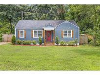 Charming blue home with a well-manicured lawn and a welcoming red front door at 2728 Mcafee Rd, Decatur, GA 30032
