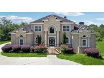 Elegant brick home with symmetrical design, arched windows, and beautifully landscaped front yard at 5661 Rutland Trce, Lithonia, GA 30058