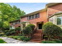 Charming red brick townhome with well-maintained landscaping and a welcoming entrance at 1378 Sheffield Glen Ne Way, Atlanta, GA 30329