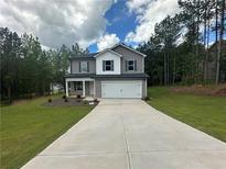 Charming two-story home with gray siding, white trim, and an attached two-car garage at 15 Fontana Ct, Covington, GA 30016